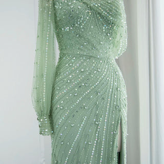 Emerald Allure: One-Shoulder Sage Green Mermaid Gown with Dubai-Inspired Gold Highlights and High Slit - A Regal Selection for Proms, Weddings, and Formal Events.