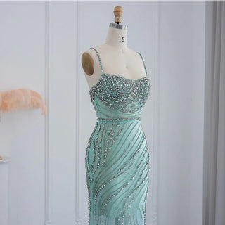 Dubai Sunset Radiance: Orange Spaghetti Straps Mermaid Evening Dress with Luxury Crystal Embellishments, Perfect for Women at Wedding Parties and Proms.