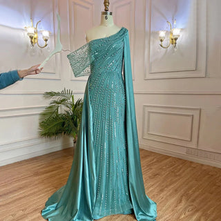 Golden Mirage: One-Shoulder Champagne Mermaid Evening Gown with Beaded Cape Sleeve - Dubai-Inspired Elegance for Arabic Weddings and Grand Celebrations.