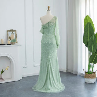 Emerald Allure: One-Shoulder Sage Green Mermaid Gown with Dubai-Inspired Gold Highlights and High Slit - A Regal Selection for Proms, Weddings, and Formal Events.