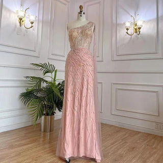 Desert Blossom: One-Shoulder Blush Pink Mermaid Evening Gown with Cape, Accented in Dubai-Inspired Emerald Green - A Luxurious Ensemble for Weddings and Grand Parties.