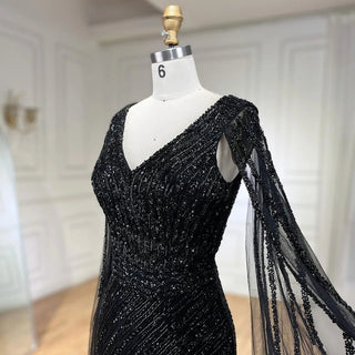 Midnight Majesty: 2024 Black Mermaid Evening Gown with Cape Sleeves and High Split - Luxury Beaded Feathers Dress for Women's Party