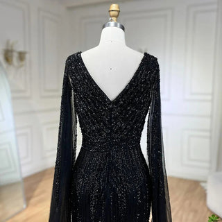 Midnight Majesty: 2024 Black Mermaid Evening Gown with Cape Sleeves and High Split - Luxury Beaded Feathers Dress for Women's Party