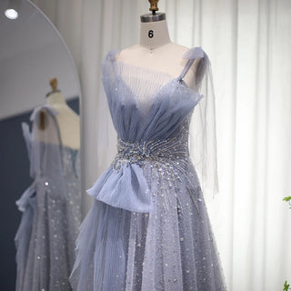 Dubai Dawn: Blush Pink Gown with Elegant Blue Accents and Spaghetti Straps for Wedding Formals.