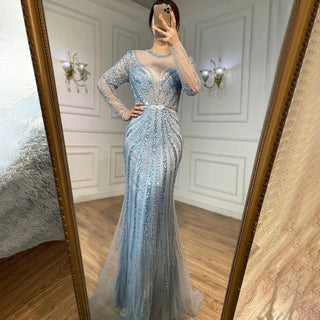 Dubai Sapphire Elegance: Luxury Blue Mermaid Evening Dress with Long Sleeves, Beaded Details, and a Belt, Ideal for Arabic Women at Wedding and Formal Parties.