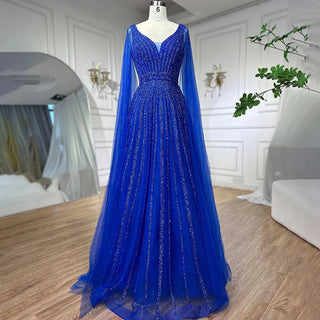 Desert Mirage: Dubai-Inspired Nude Evening Gown with Cape Sleeves Accented in Elegant Blue - A Vision of Grace for Weddings and Celebrations.