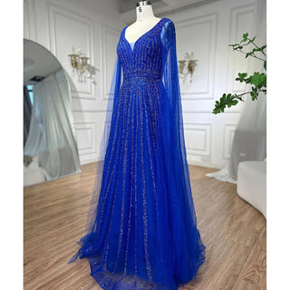 Desert Mirage: Dubai-Inspired Nude Evening Gown with Cape Sleeves Accented in Elegant Blue - A Vision of Grace for Weddings and Celebrations.