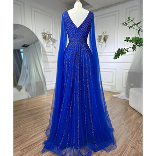 Desert Mirage: Dubai-Inspired Nude Evening Gown with Cape Sleeves Accented in Elegant Blue - A Vision of Grace for Weddings and Celebrations.