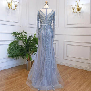 Dubai Sapphire Elegance: Luxury Blue Mermaid Evening Dress with Long Sleeves, Beaded Details, and a Belt, Ideal for Arabic Women at Wedding and Formal Parties.