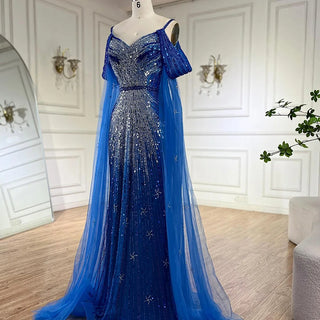 Ships in 1 to 3 Days - 2024 Spaghetti Strap Blue Mermaid Beaded Evening Gown with Cape Sleeves - Luxury Dress