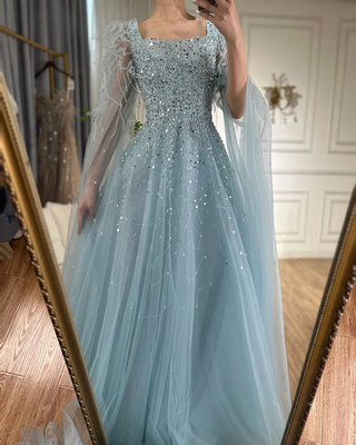 Ships in 1 to 3 Days - 2024 Arabic Blue A-Line Evening Dress - Luxury Beaded Gown with Feathers and Cape Sleeves for Formal Occasions in Saudi Arabia