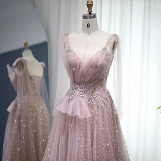 Dubai Dawn: Blush Pink Gown with Elegant Blue Accents and Spaghetti Straps for Wedding Formals.