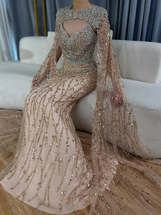 Ships in 1 to 3 Days – 2024 Nude Mermaid Evening Gown with Beaded Crystal Detailing and Removable Cape Sleeves for Formal Occasions