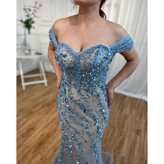 Ocean Opulence: 2024 Blue Mermaid Evening Gown with Beaded Off-Shoulder Detail