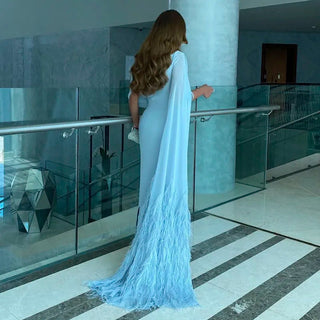 Azure Elegance: Light Blue Arabic Evening Gown with Feathered Cape - Dubai-Inspired Luxury for Women's Weddings and Grand Parties.