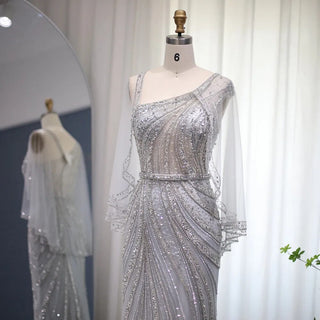 Champagne Elegance: Dubai-Inspired Mermaid Evening Gown with Silver Cape Accent - One-Shoulder Wonder for Proms, Weddings, and Grand Soirees.