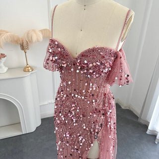 Desert Rose Allure: Dubai-Inspired Mermaid Pink Evening Gown with Delicate Spaghetti Straps and High Blue Slit - The Pinnacle of Elegance for Proms and Wedding Parties.