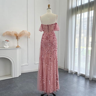 Desert Rose Allure: Dubai-Inspired Mermaid Pink Evening Gown with Delicate Spaghetti Straps and High Blue Slit - The Pinnacle of Elegance for Proms and Wedding Parties.