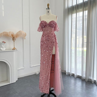 Desert Rose Allure: Dubai-Inspired Mermaid Pink Evening Gown with Delicate Spaghetti Straps and High Blue Slit - The Pinnacle of Elegance for Proms and Wedding Parties.