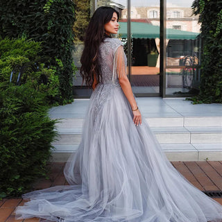 Dubai Silver Elegance: Luxury Overskirt Evening Dress with Tassel Accents, Designed for Plus Size Women, Perfect for Weddings, Parties, and Proms with Arabic Elegance.