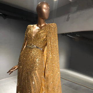 Golden Oasis: Dubai-Inspired Evening Gown Adorned with Sparkly Beads and Elegant Cape - A Dazzling Choice for Weddings and Grand Soirees.