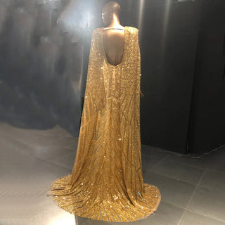 Golden Oasis: Dubai-Inspired Evening Gown Adorned with Sparkly Beads and Elegant Cape - A Dazzling Choice for Weddings and Grand Soirees.