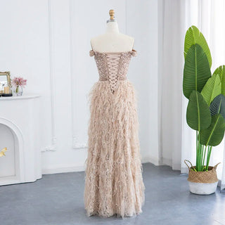 Golden Plume Elegance: Champagne Mermaid Evening Gown with Dubai-Inspired Feathers - Off-the-Shoulder Grandeur for Proms and Formal Events.