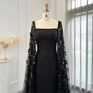 Midnight Blossom: Black Satin Arabic Gown with 3D Flowers and Elegant Mermaid Cape for Formal Events.