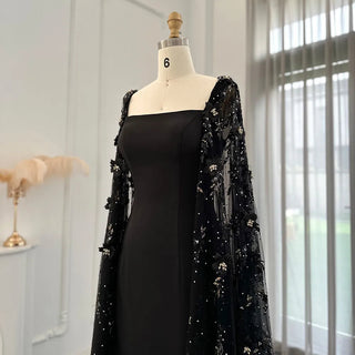 Midnight Blossom: Black Satin Arabic Gown with 3D Flowers and Elegant Mermaid Cape for Formal Events.