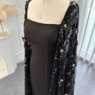 Midnight Blossom: Black Satin Arabic Gown with 3D Flowers and Elegant Mermaid Cape for Formal Events.