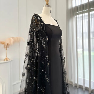 Midnight Blossom: Black Satin Arabic Gown with 3D Flowers and Elegant Mermaid Cape for Formal Events.