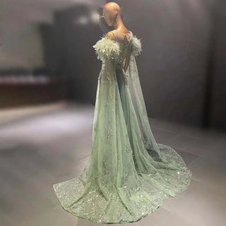 Ships in 1 to 3 Days – Minted Elegance: Dubai-Inspired Evening Gown in Mint Green with Feathered Cape Sleeve - The Epitome of Arabic Grace for Weddings and Formal Soirees.