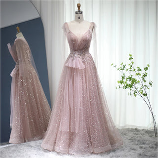 Dubai Dawn: Blush Pink Gown with Elegant Blue Accents and Spaghetti Straps for Wedding Formals.