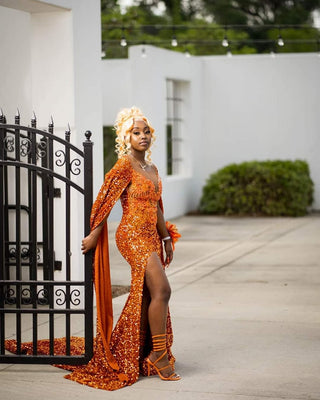 Show-Stopping Orange Sequin Gown with High Slit and Flowing Cape