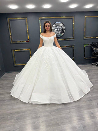 Whispering Elegance Bridal Gown with Off-Shoulder Design and Delicate Beaded Lace