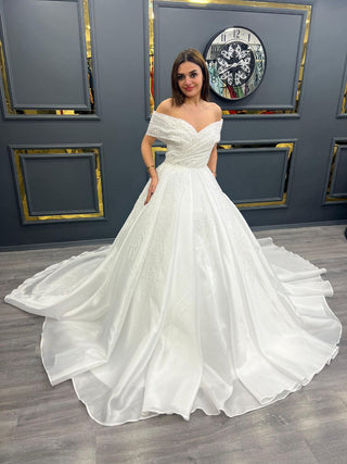 Elegant Off-Shoulder Beaded Wedding Gown with Flowing Train