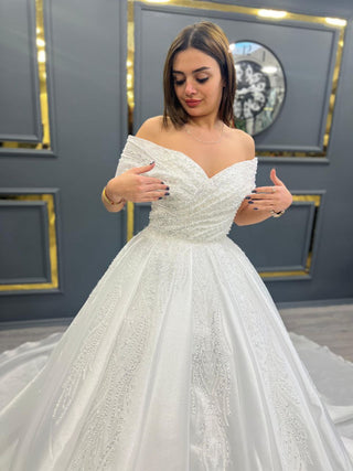 Elegant Off-Shoulder Beaded Wedding Gown with Flowing Train