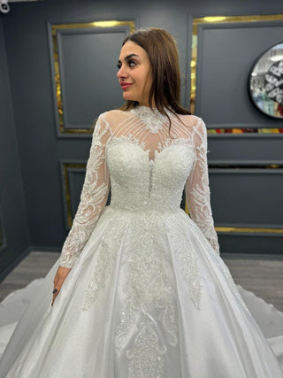 Graceful High-Neck Beaded Wedding Gown with Illusion Sleeves and Flowing Train