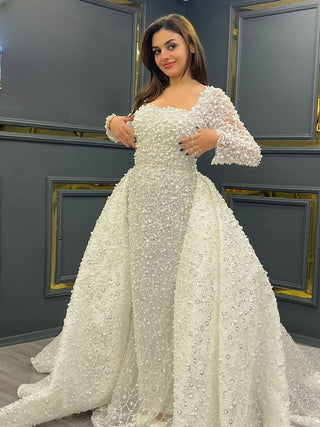 Exquisite Pearl-Embellished Wedding Gown with Sheer Sleeves and Flowing Train