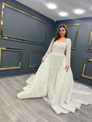 Exquisite Pearl-Embellished Wedding Gown with Sheer Sleeves and Flowing Train