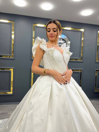 Majestic Pearl-Embellished Ball Gown with Ruffled Sleeves and Bow Detail