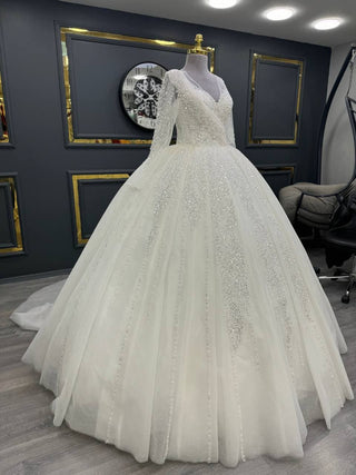 Extravagant Long-Sleeve Beaded Ball Gown with Crisscross Bodice and Glittering Embellishments