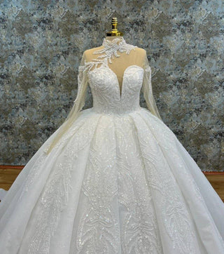 Luxurious Long-Sleeve Illusion High Neck Beaded Ball Gown with Dramatic Appliqué and Intricate Beading