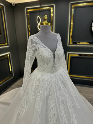 Exquisite Long-Sleeve Ball Gown Wedding Dress with Intricate Beading and Plunging Illusion Neckline