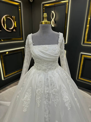 Luxurious Draped Bodice Ball Gown Wedding Dress with Long Sleeves and Intricate Floral Embellishments