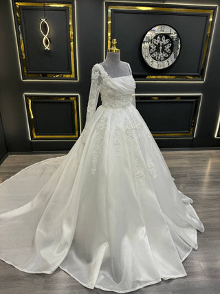 Luxurious Draped Bodice Ball Gown Wedding Dress with Long Sleeves and Intricate Floral Embellishments