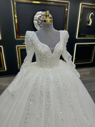 Opulent Long Sleeve Wedding Dress with Deep V-Neckline and Glittering Beaded Appliques