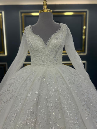 Luxurious Beaded Ball Gown Wedding Dress with Long Sheer Sleeves and Intricate Floral Embellishments