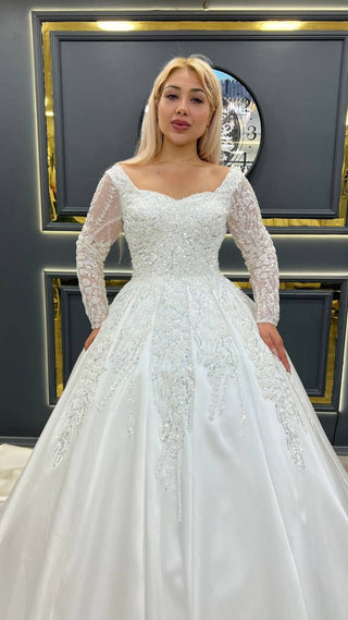 Exquisite Princess Ball Gown Wedding Dress with Sheer Beaded Sleeves and Intricate Lace Appliques