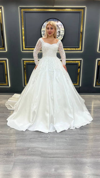 Exquisite Princess Ball Gown Wedding Dress with Sheer Beaded Sleeves and Intricate Lace Appliques